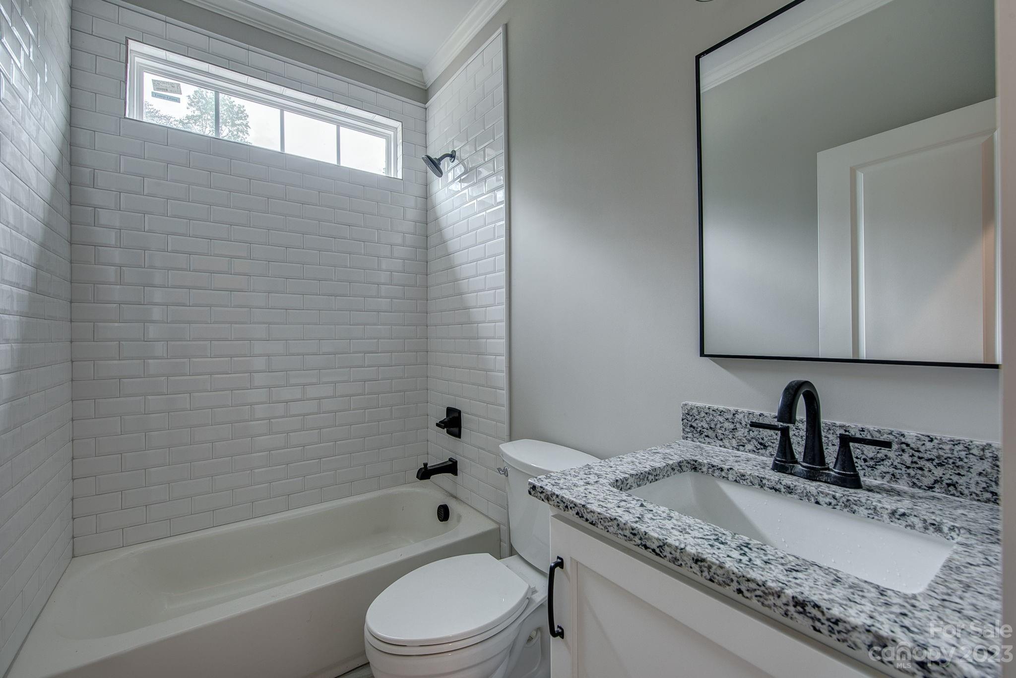 2911 Sparrow Springs Road Gastonia, NC 28052 - Photo 25 of 31 a bathroom with a granite countertop sink toilet and shower
