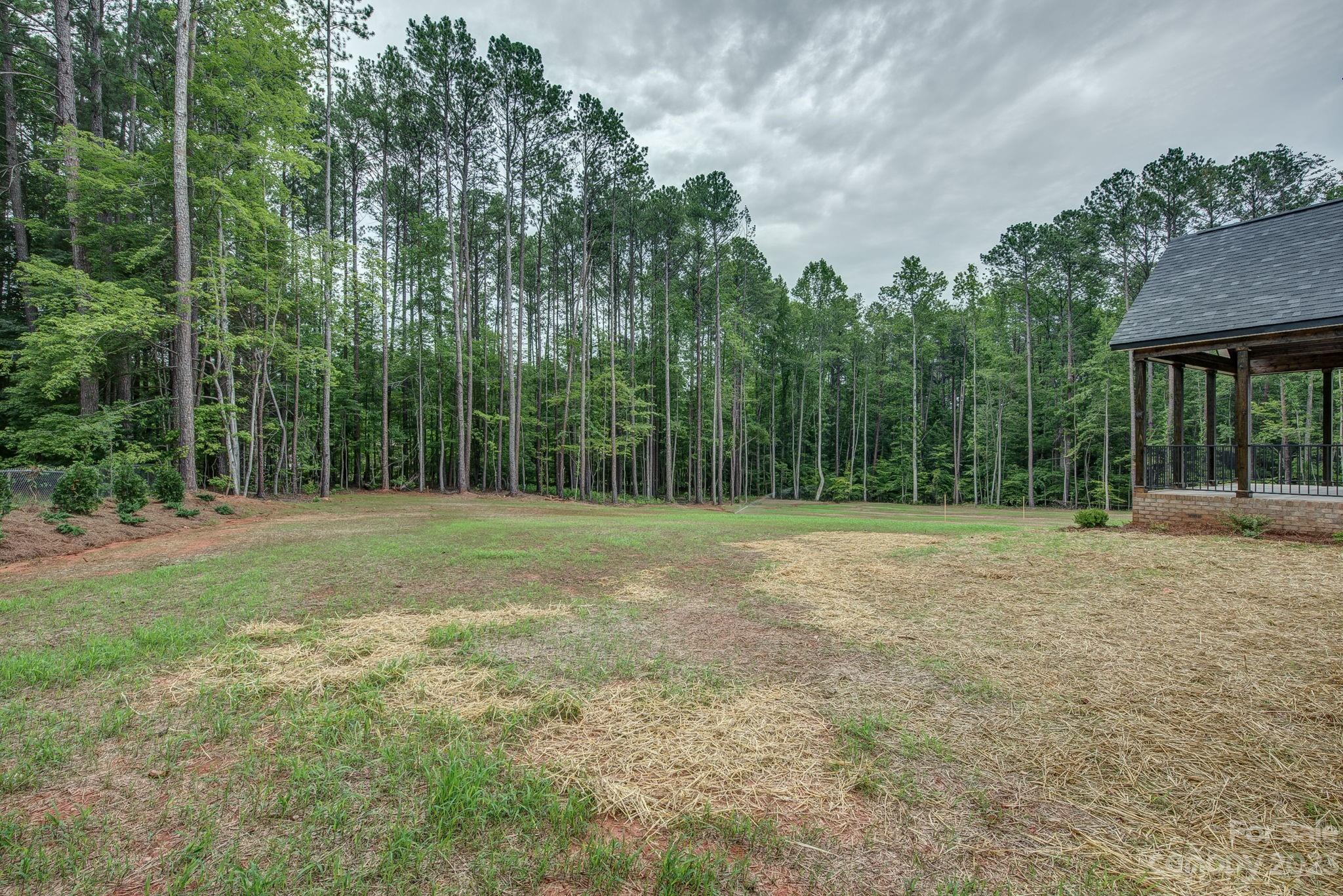 2911 Sparrow Springs Road Gastonia, NC 28052 - Photo 29 of 31 a view of a field with trees in the background
