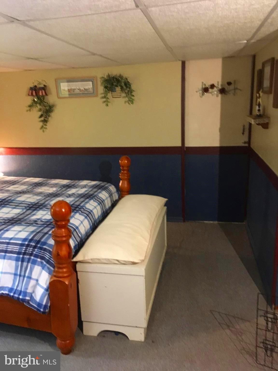 1919 Marsdale Road Baltimore, MD 21222 - Photo 22 of 27 a bedroom with a bed and dresser