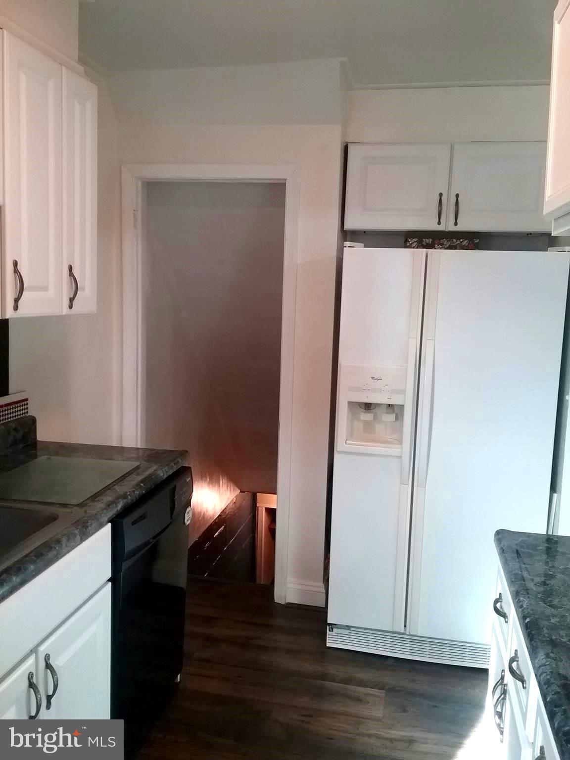 1919 Marsdale Road Baltimore, MD 21222 - Photo 8 of 27 a kitchen with a refrigerator and a stove