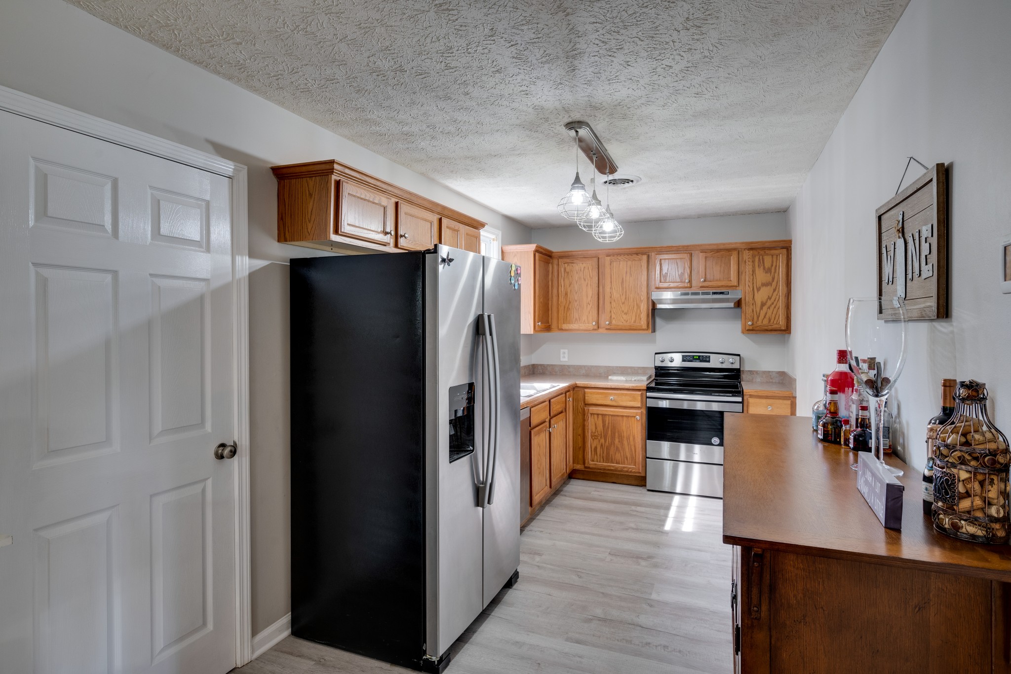 211 Westwind Drive Springfield, TN 37172 - Photo 11 of 33 a kitchen with stainless steel appliances a refrigerator stove and sink