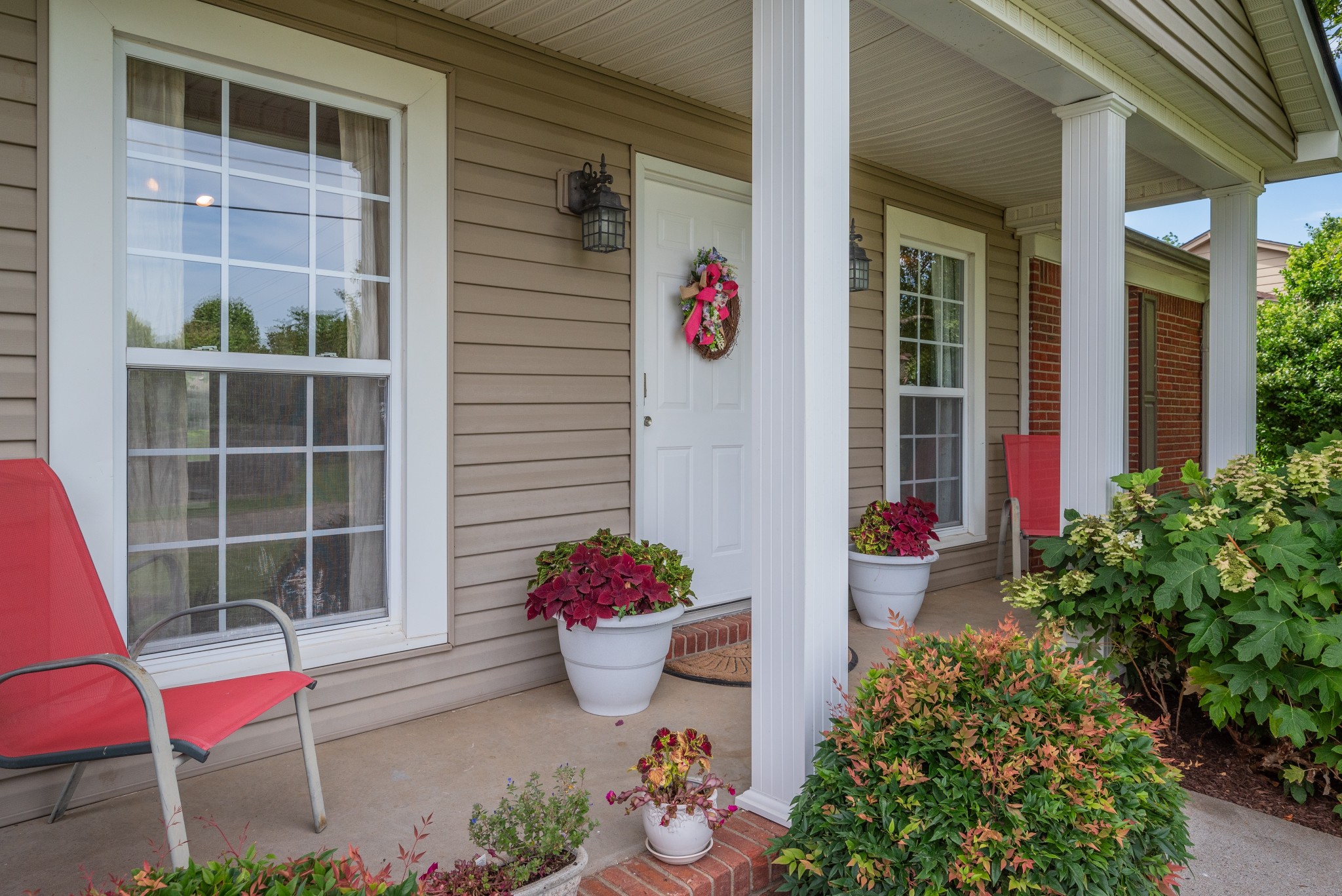 211 Westwind Drive Springfield, TN 37172 - Photo 4 of 33 a front view of a house with a potted plant and a fountain
