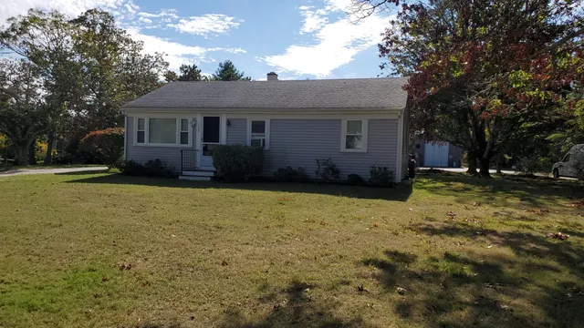 a front view of a house with a yard