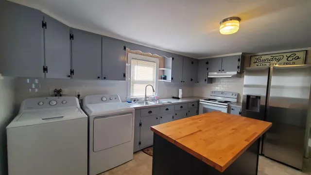 a kitchen with a stove a sink and a refrigerator