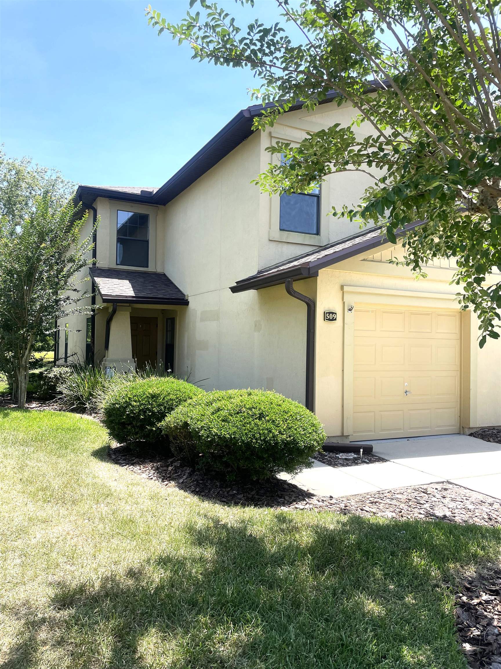 a front view of a house with a yard and garage