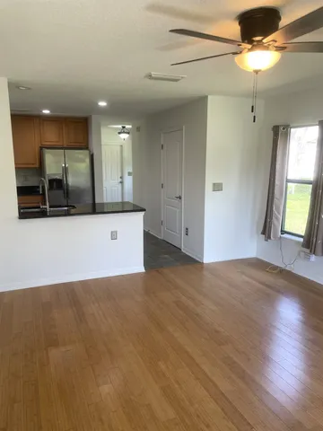 a view of a kitchen with a sink and a large window