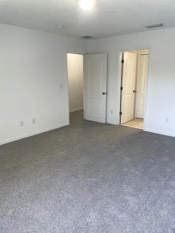 a view of an empty room and closet area