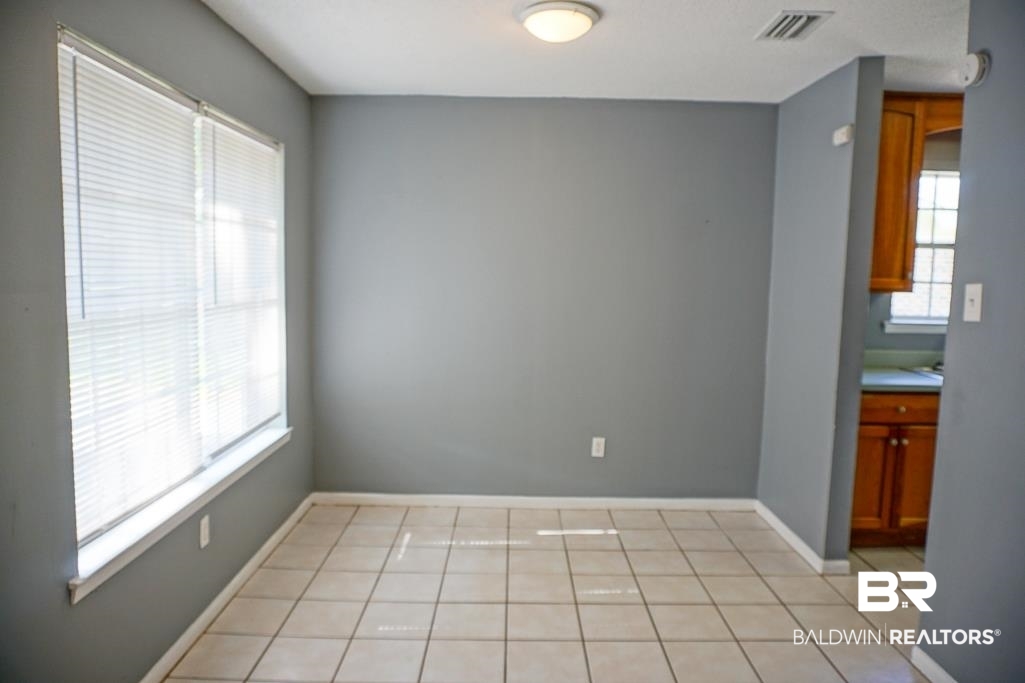 4366 Fathbrook Lane Mobile, AL 36693 - Photo 9 of 14 Unfurnished dining area featuring baseboards and light tile patterned floors
