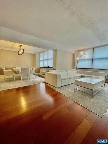 a view of a kitchen with kitchen island a sink stainless steel appliances and cabinets