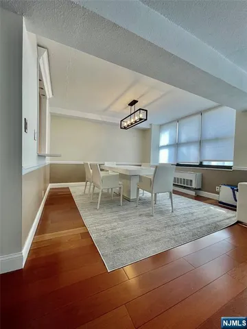 a view of kitchen and dining room with wooden floor