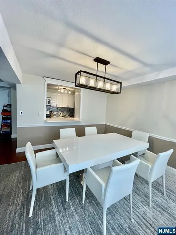 a view of a dining room with furniture and a rug