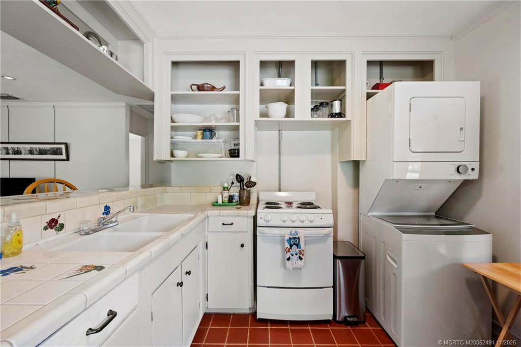 120 Southwest 5th Street Stuart, FL 34994 - Photo 14 of 35 a utility room with cabinets washer and dryer