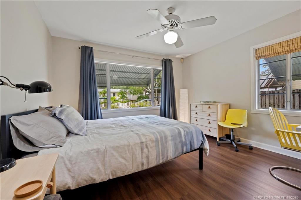 120 Southwest 5th Street Stuart, FL 34994 - Photo 18 of 35 a bedroom with a bed and wooden floor