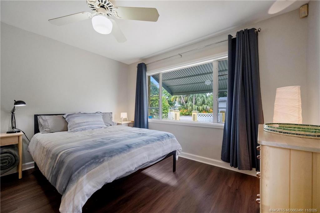 120 Southwest 5th Street Stuart, FL 34994 - Photo 19 of 35 a bedroom with a large bed and a large window