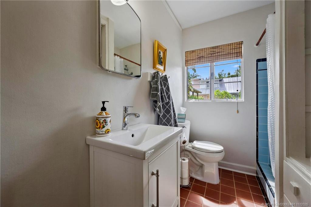 120 Southwest 5th Street Stuart, FL 34994 - Photo 21 of 35 a bathroom with a sink toilet and a mirror