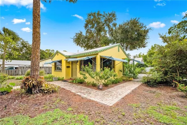 an aerial view of residential houses with outdoor space and ocean view