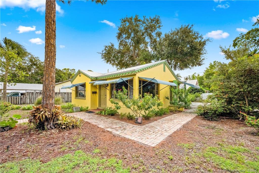 120 Southwest 5th Street Stuart, FL 34994 - Photo 23 of 35 a front view of a house with a yard and potted plants