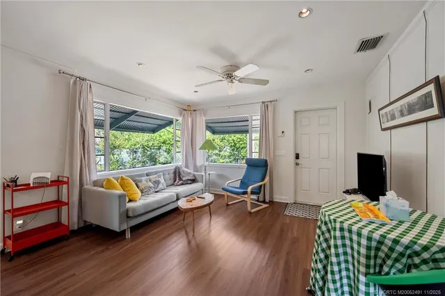 a view of hall way with furniture and wooden floor