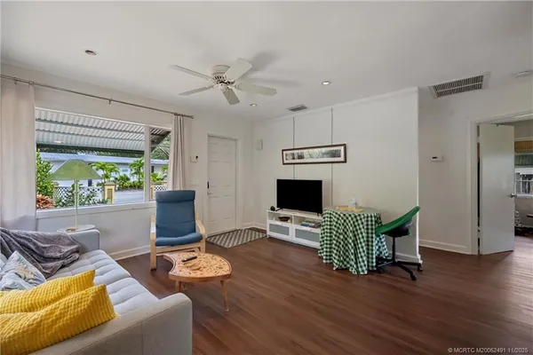 a view of hall way with furniture and wooden floor