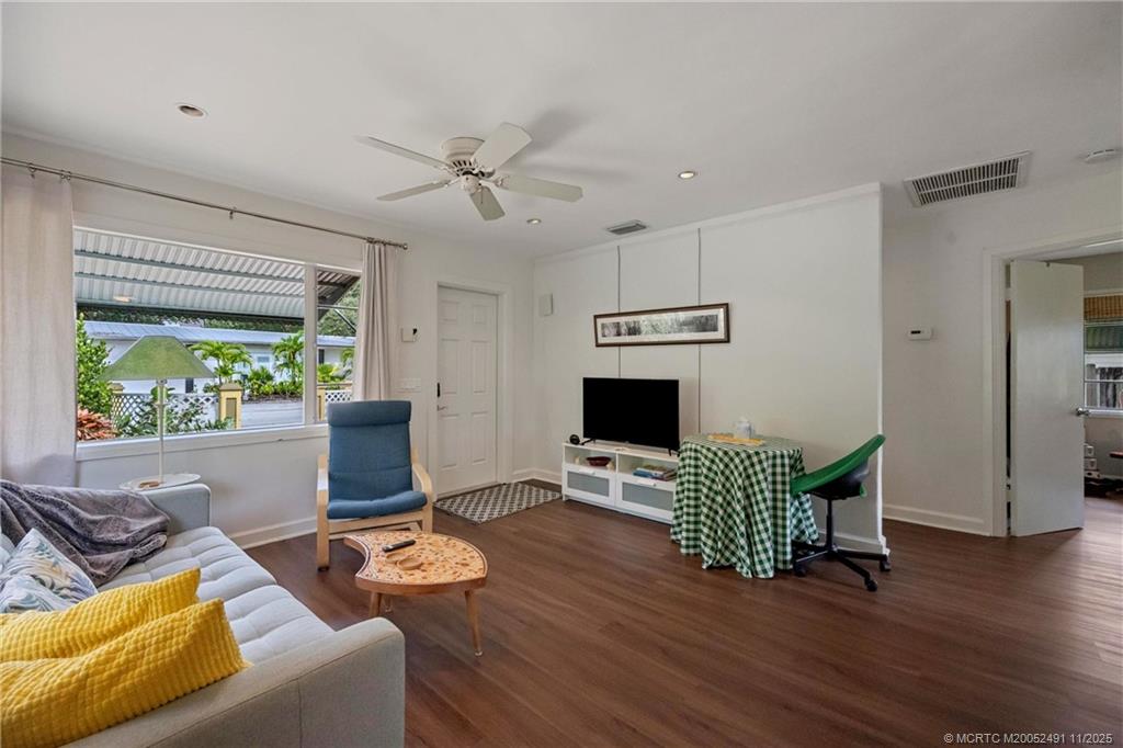 120 Southwest 5th Street Stuart, FL 34994 - Photo 10 of 35 a living room with furniture a window and a flat screen tv