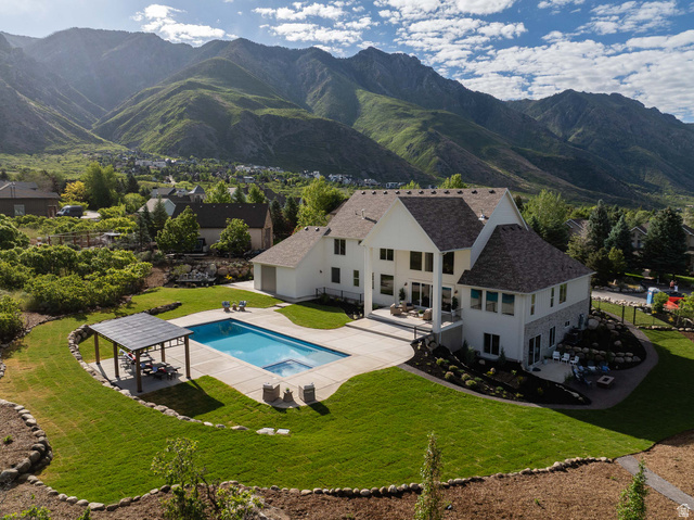 4292 Silver Sage Circle Alpine, UT 84004 - Photo 1 of 41 Two-story home with a multi-level roofline, a large rear patio, and a swimming pool with an integrated spa