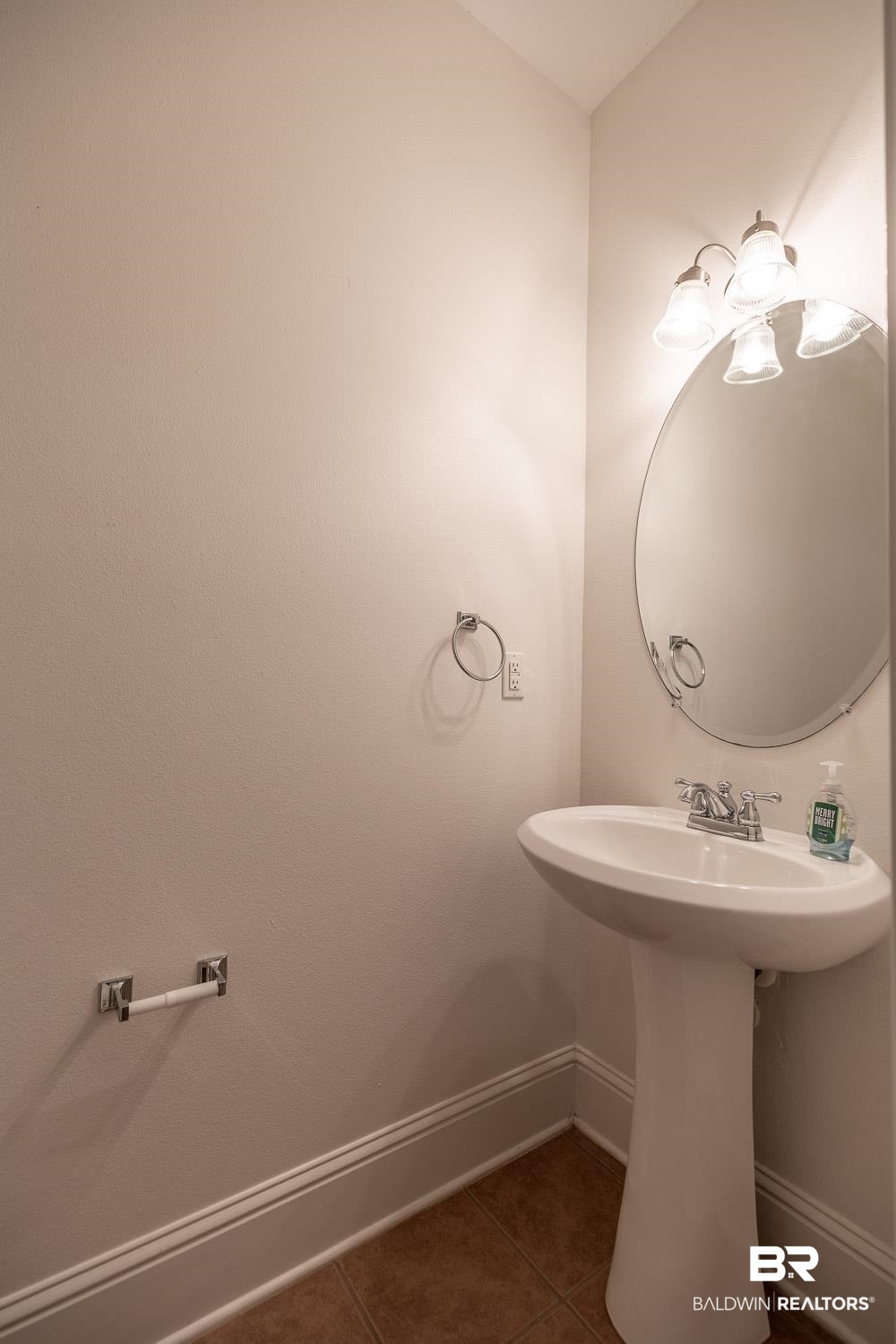 101 Normandy Street Fairhope, AL 36532 - Photo 6 of 18 Bathroom with dark tile patterned flooring and baseboards