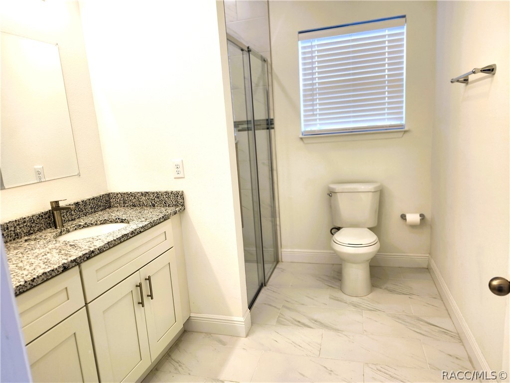 2800 Southwest 139th Street Ocala, FL 34473 - Photo 11 of 16 a white toilet sitting next to a bathroom sink