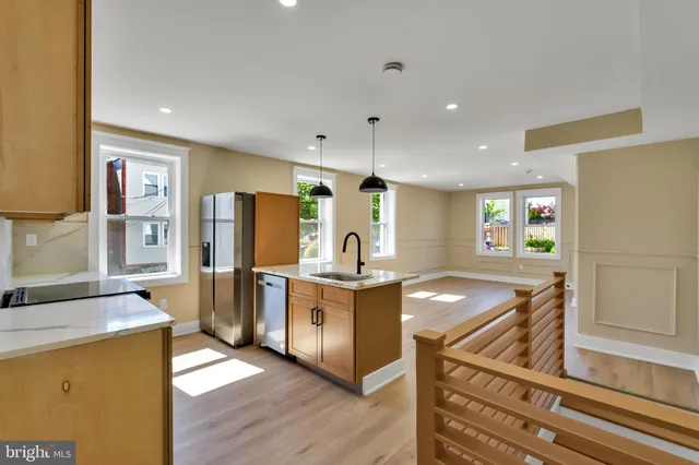 a kitchen with stainless steel appliances granite countertop a stove oven and a refrigerator