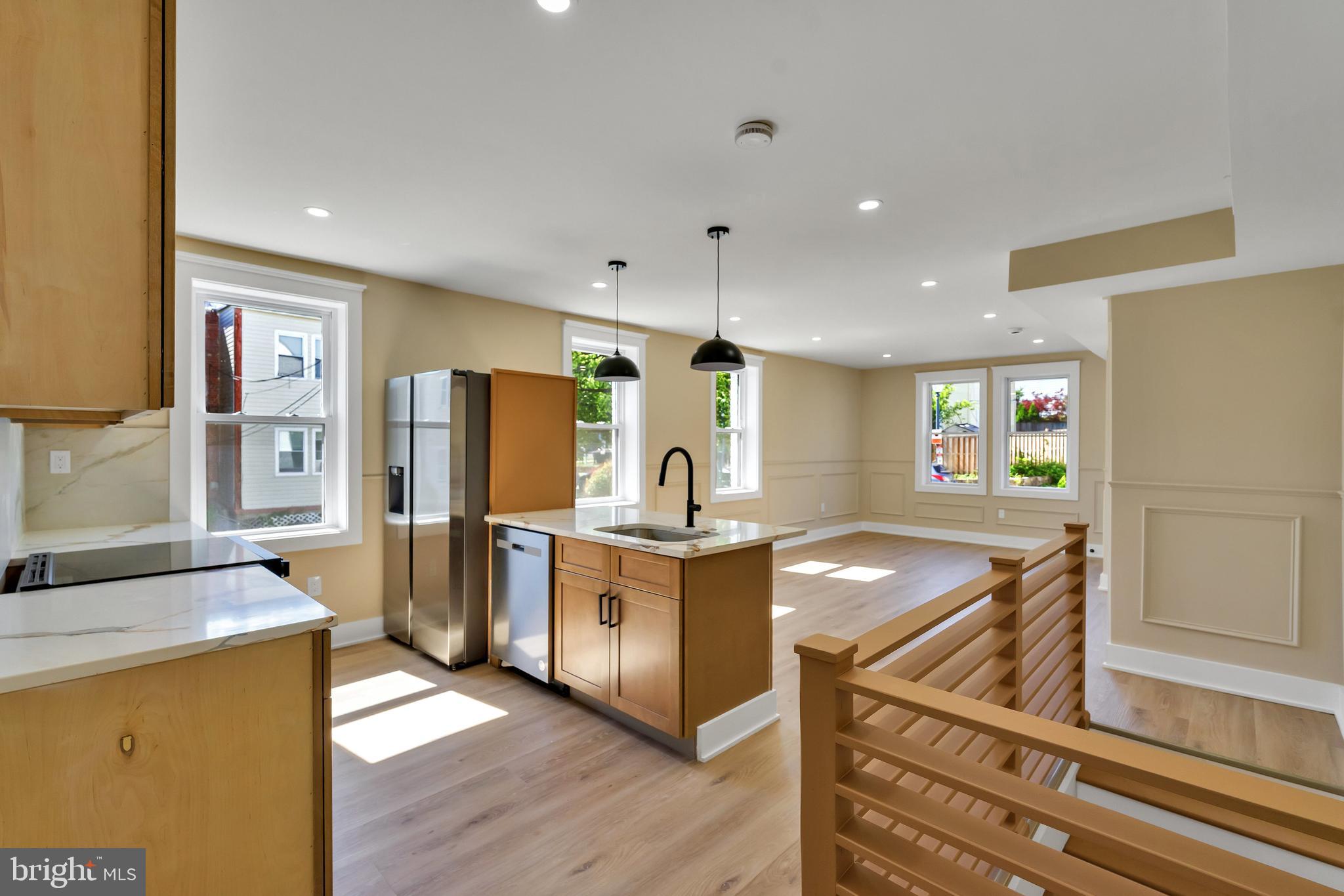 a kitchen with stainless steel appliances granite countertop a stove oven and a refrigerator