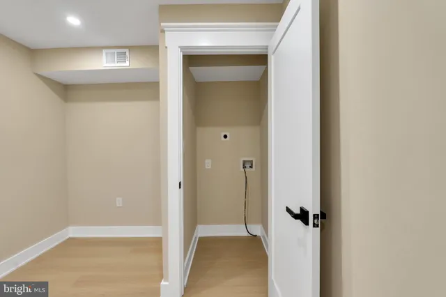 an empty room with windows and closet