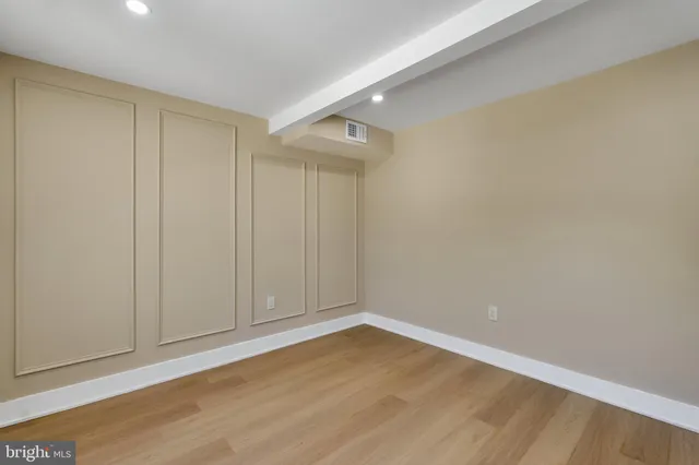 a view of a hallway with wooden floor and entryway