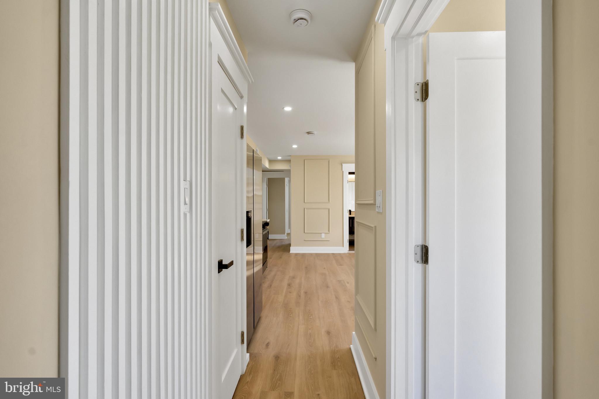 1274 Meigs Place Northeast Washington, DC 20002 - Photo 40 of 57 a view of a hallway with wooden floor and a bathroom