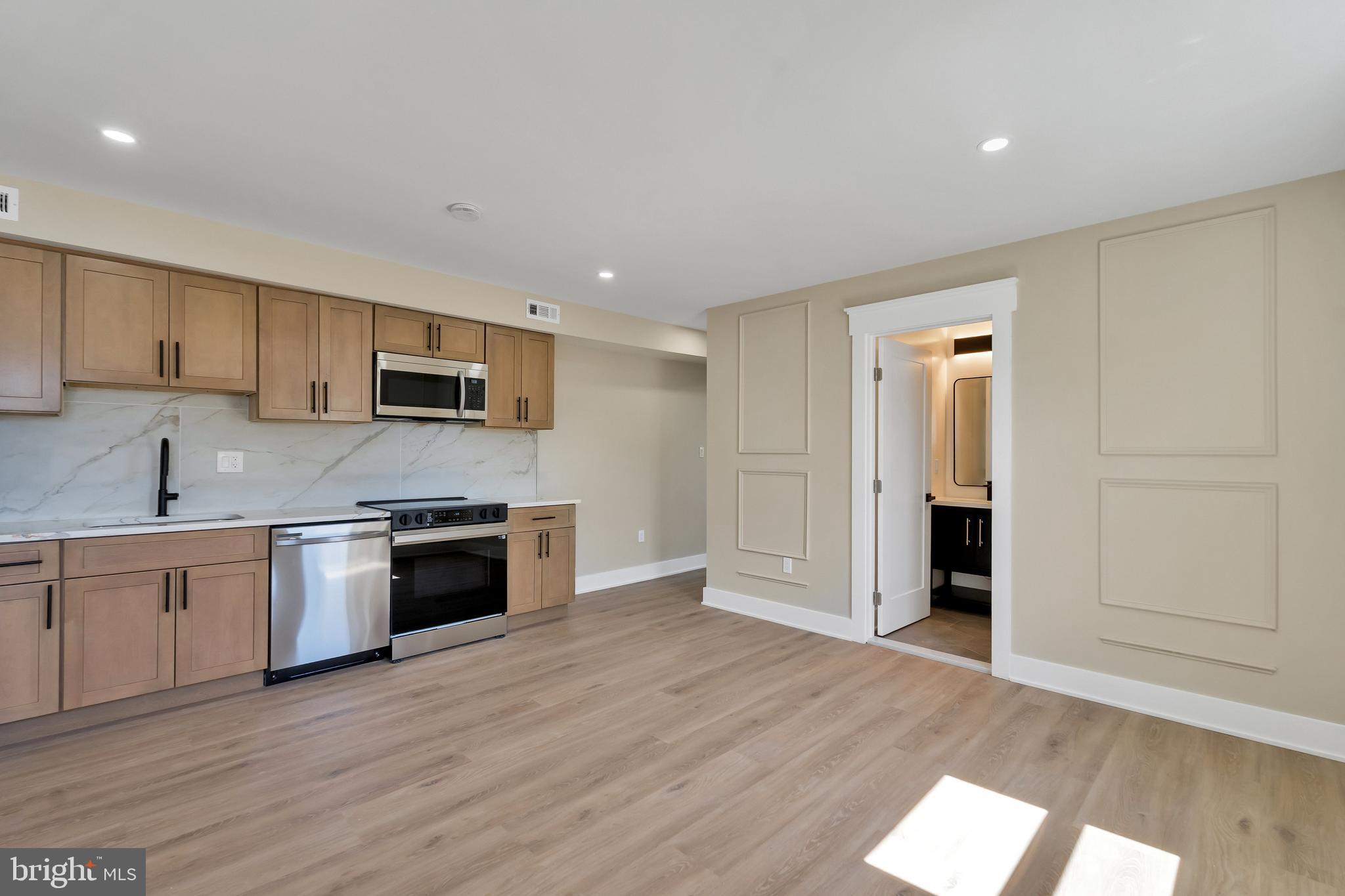 1274 Meigs Place Northeast Washington, DC 20002 - Photo 44 of 57 a large kitchen with stainless steel appliances granite countertop a stove and a refrigerator
