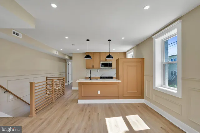 a kitchen with a appliances a sink and a microwave