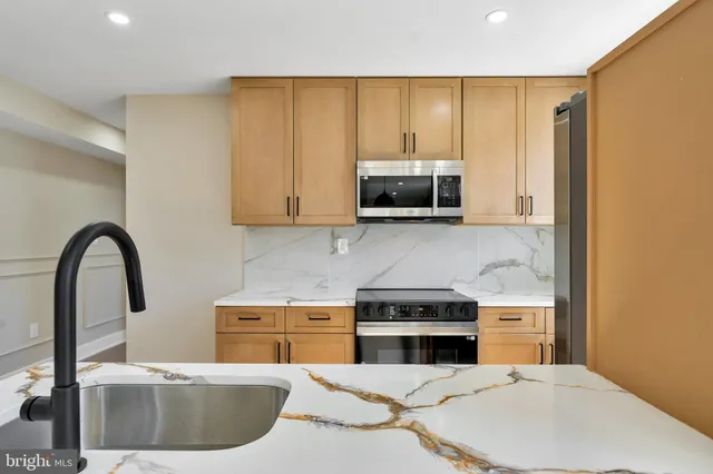 a view of kitchen with a refrigerator and a window