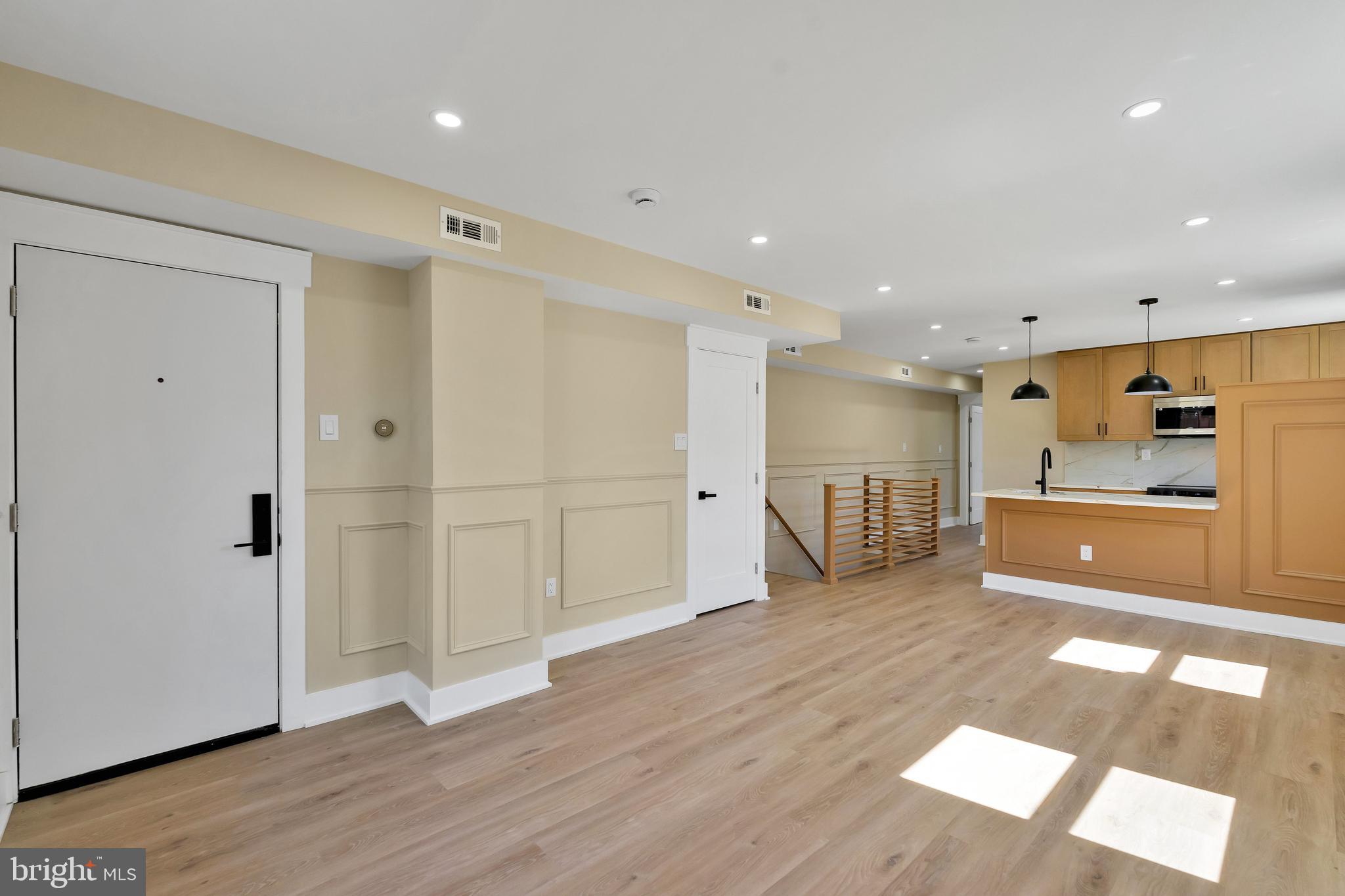 1274 Meigs Place Northeast Washington, DC 20002 - Photo 9 of 57 a view of a big room with wooden floor and windows