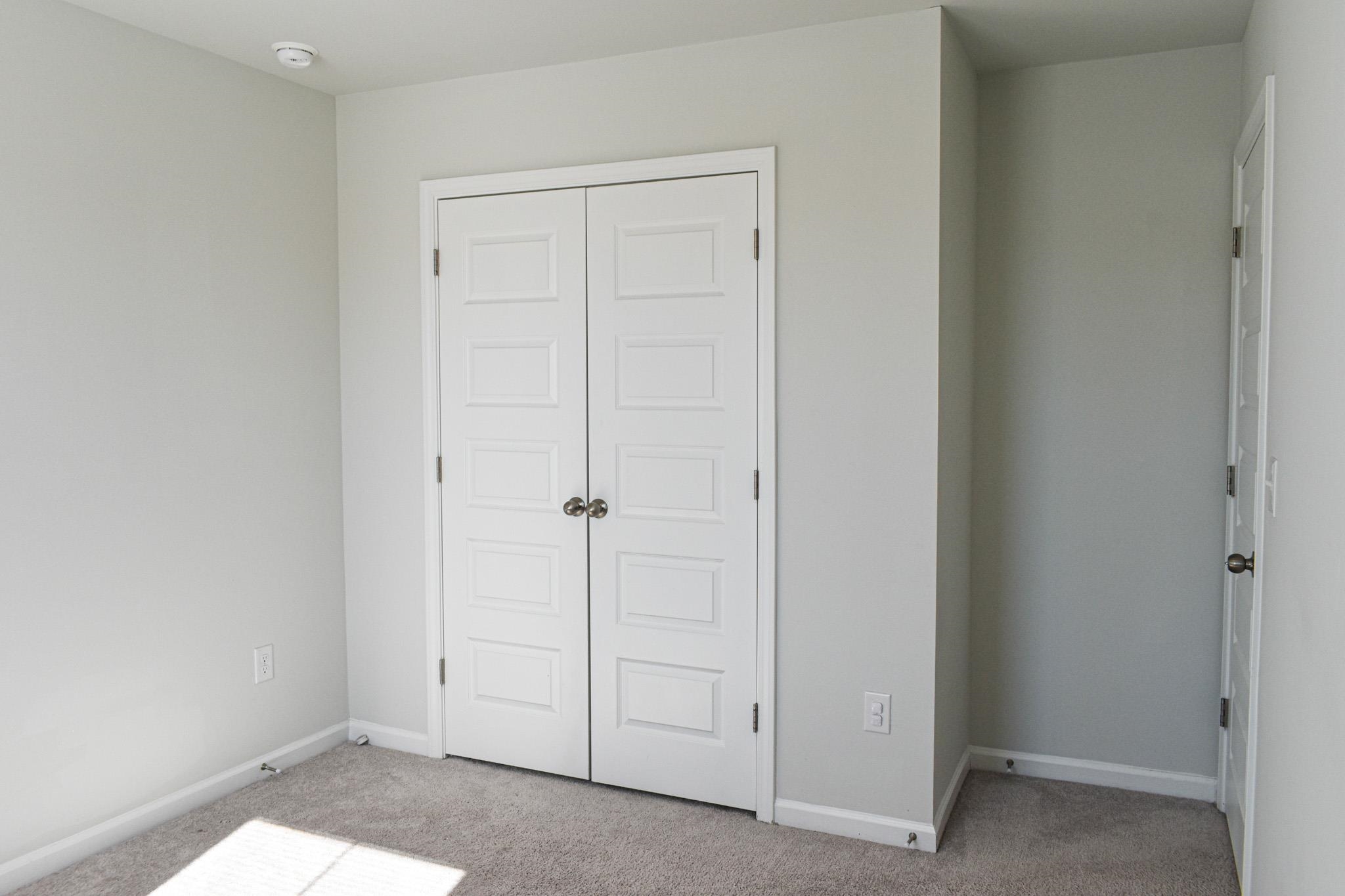 1057 Saltgrass Way Myrtle Beach, SC 29588 - Photo 11 of 23 Unfurnished bedroom featuring carpet and a closet