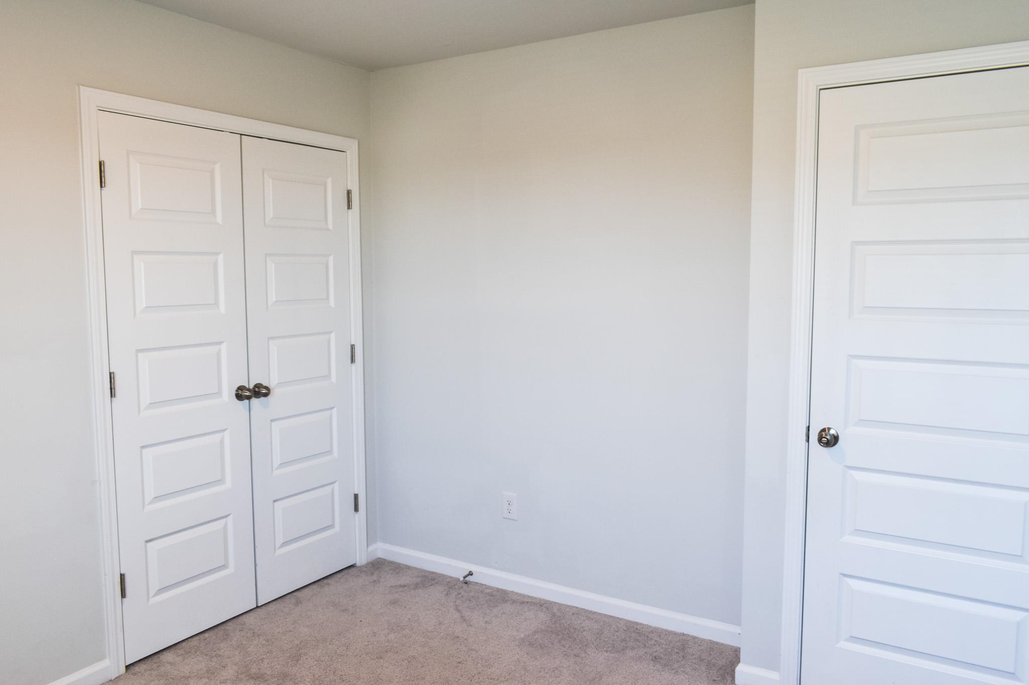 1057 Saltgrass Way Myrtle Beach, SC 29588 - Photo 8 of 23 Unfurnished bedroom with light colored carpet and baseboards