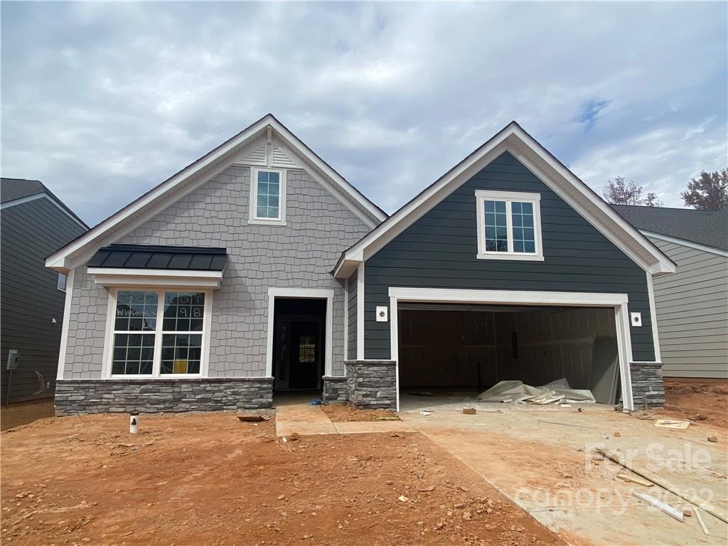 3237 Windhaven Lane, Unit 98 Tega Cay, SC 29708 - Photo 1 of 17 a front view of a house with a yard and garage