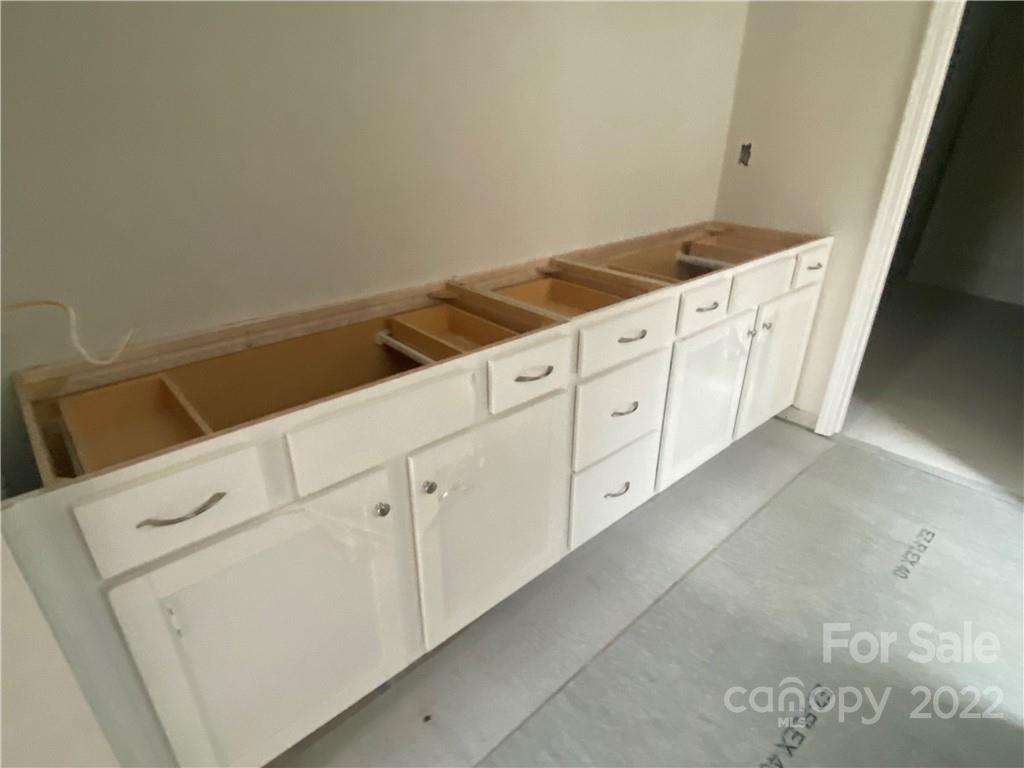 3237 Windhaven Lane, Unit 98 Tega Cay, SC 29708 - Photo 13 of 17 a view of cabinets and utility room with stair