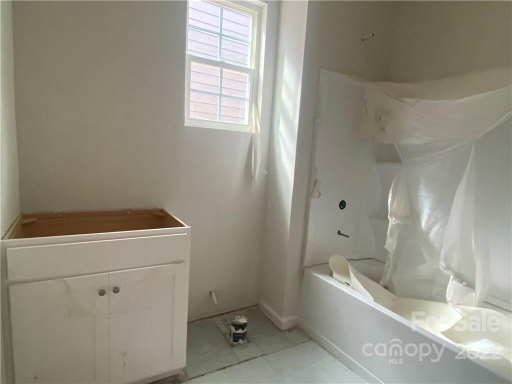 3237 Windhaven Lane, Unit 98 Tega Cay, SC 29708 - Photo 2 of 17 a bathroom with a bathtub and window