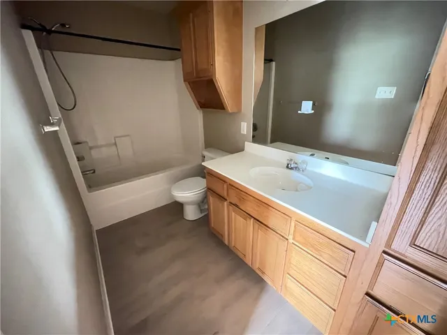 a bathroom with a sink a toilet and a shower