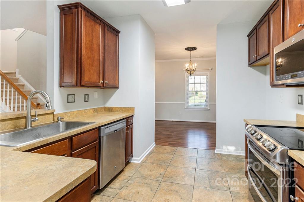 11333 Chapeclane Road Charlotte, NC 28278 - Photo 10 of 23 a kitchen with a sink stove and cabinets