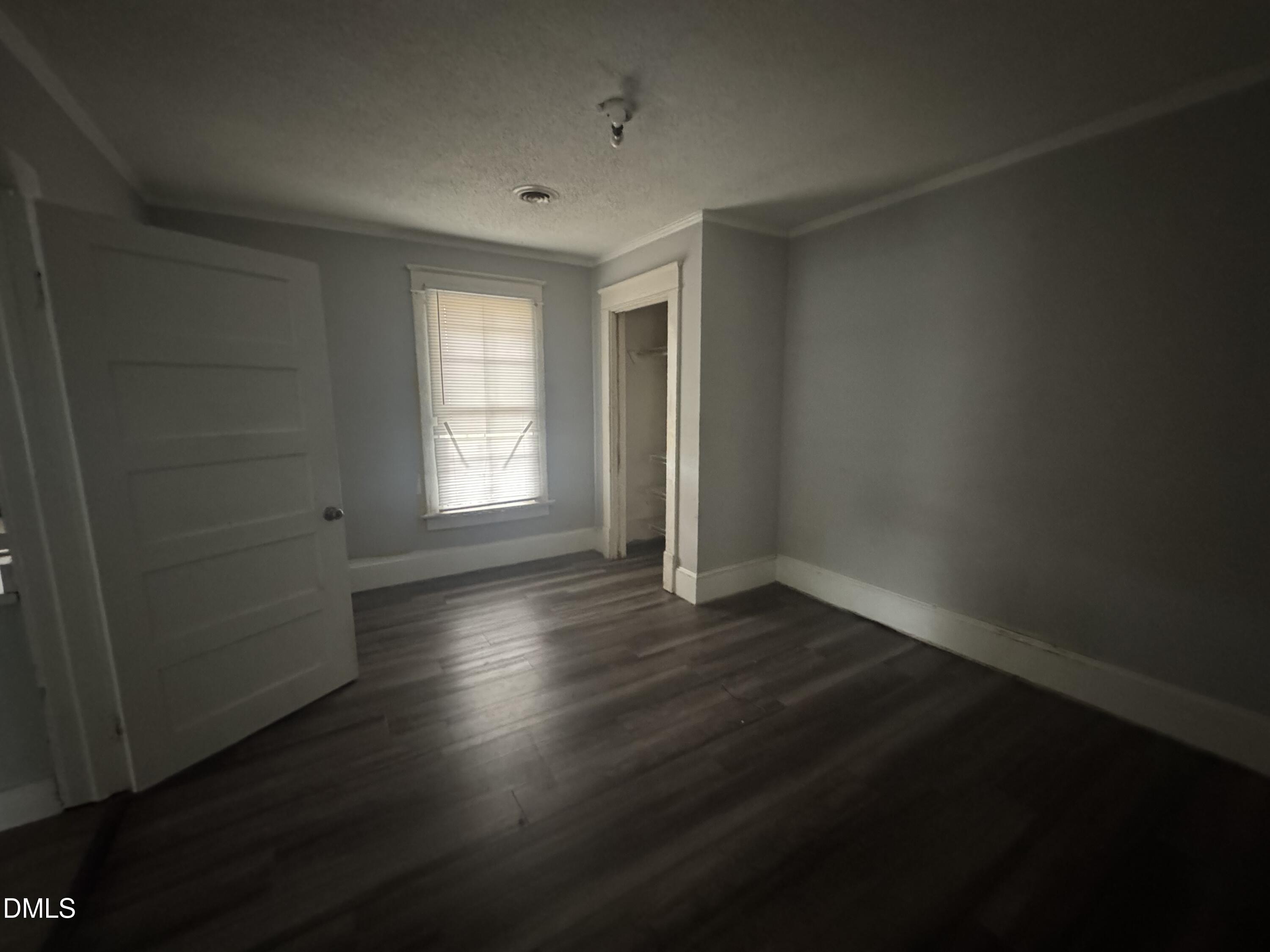 212 South 6th Street Smithfield, NC 27577 - Photo 7 of 17 an empty room with wooden floor and windows