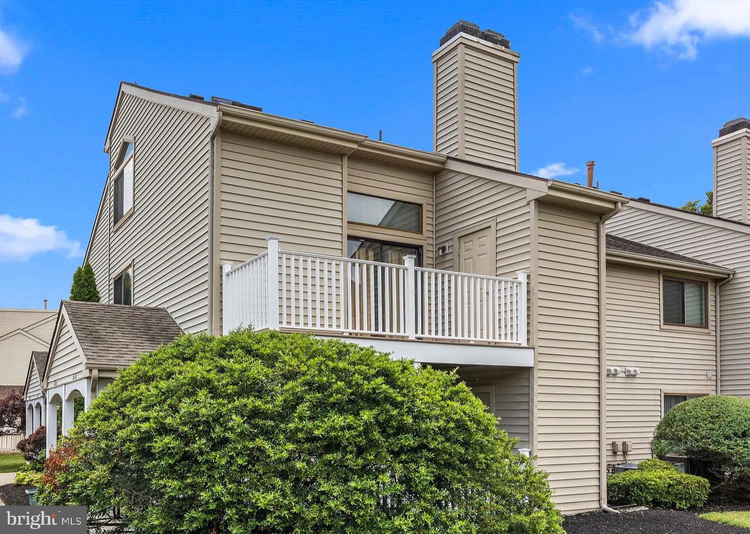 a view of a house with a yard and plants