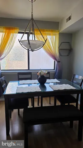 a kitchen area with table and chairs