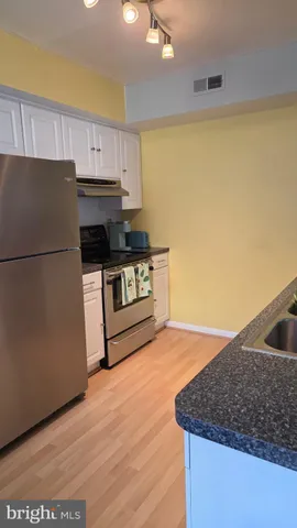 a kitchen with a sink a stove and a refrigerator