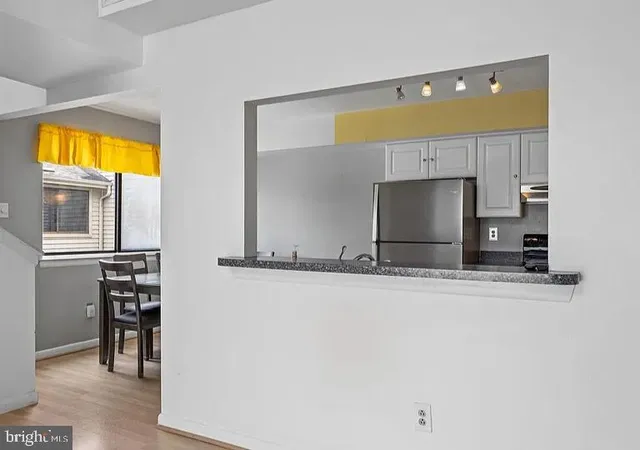 a view of a kitchen with a sink and cabinets