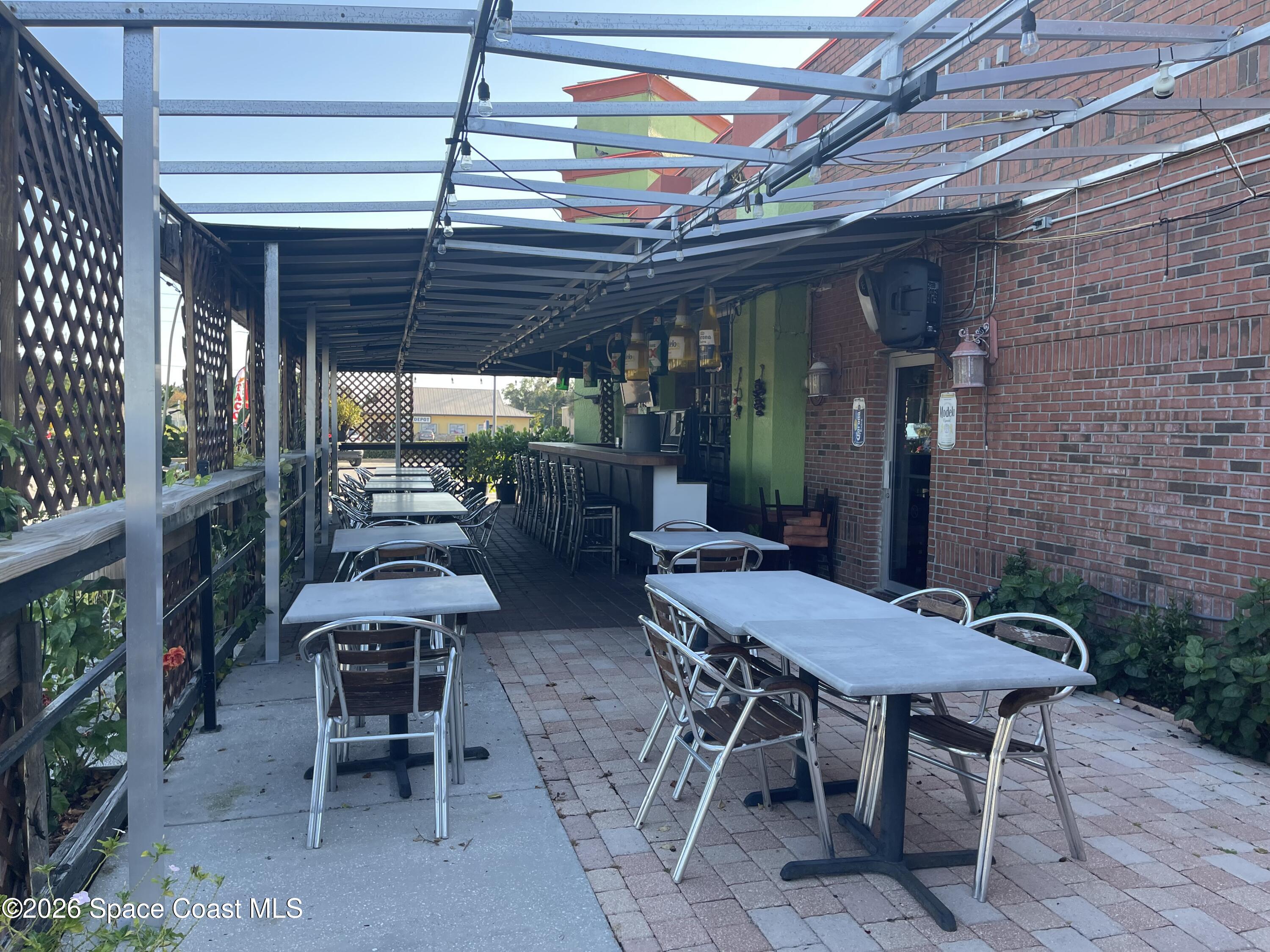 4990 Stack Boulevard Melbourne, FL 32905 - Photo 5 of 11 a view of a patio with a table and chairs and potted plants