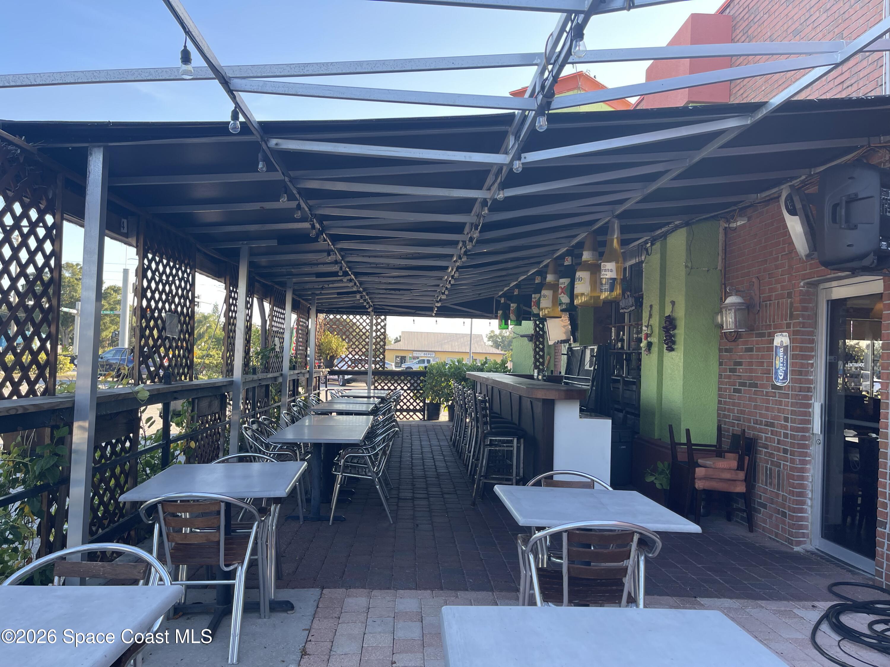 4990 Stack Boulevard Melbourne, FL 32905 - Photo 7 of 11 a view of a tables and chairs in patio